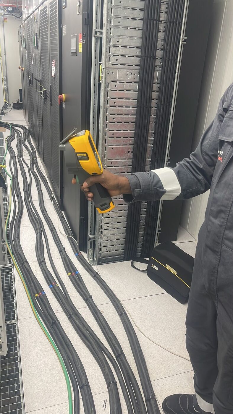 Engineer carrying out a thermal imaging survey in a data hall